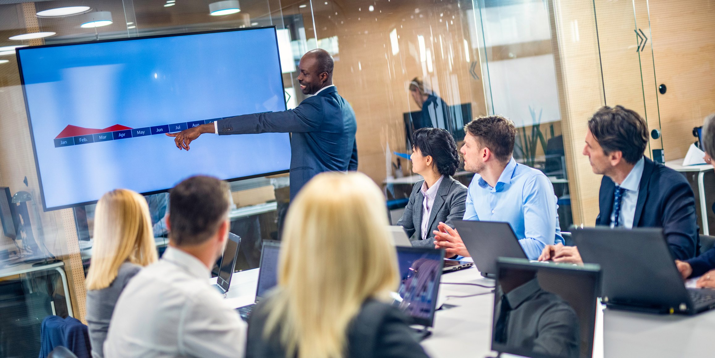 Financial analyst giving presentation to board of directors